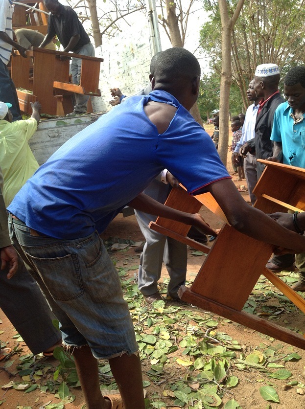 unloading desks for Masasi Villages project funded by African Palms selling palm crosses