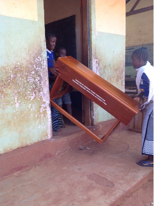 taking the desks into school for Masasi Villages project funded by African Palms selling palm crosses