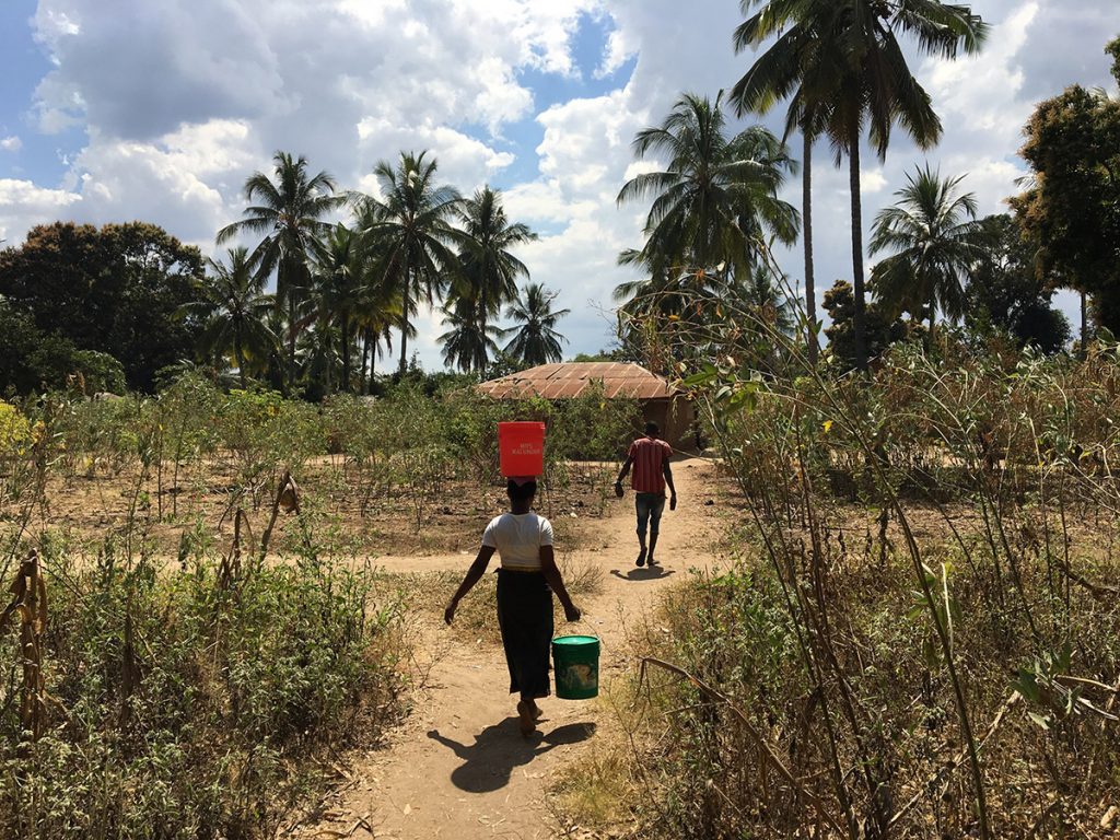 carrying at water a much shorter distante point pipeline at Chipinpinbi project funded-by  African Palms-selling palm crosses